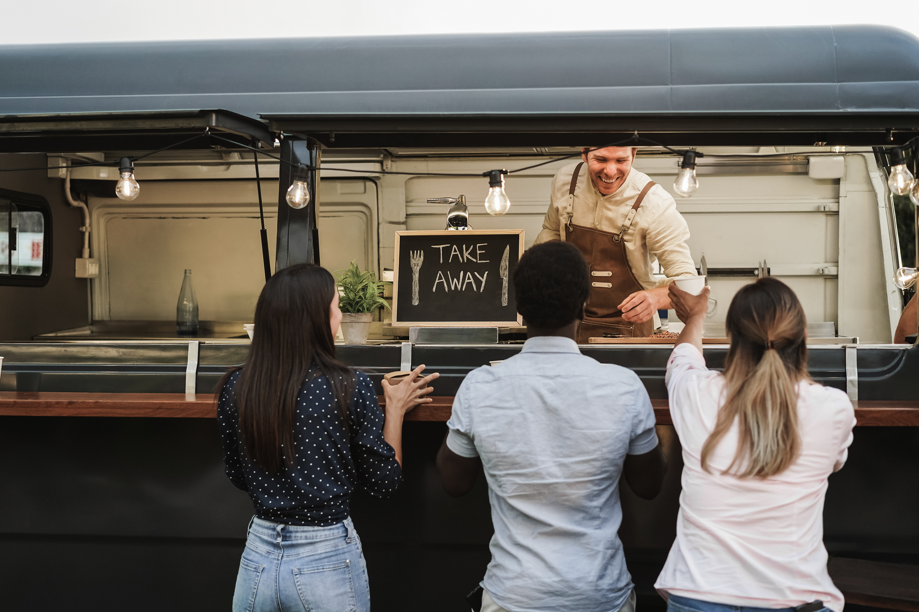 people ordering at food truck