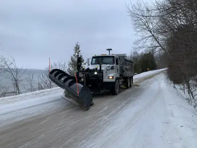 a snow plow on a winter road